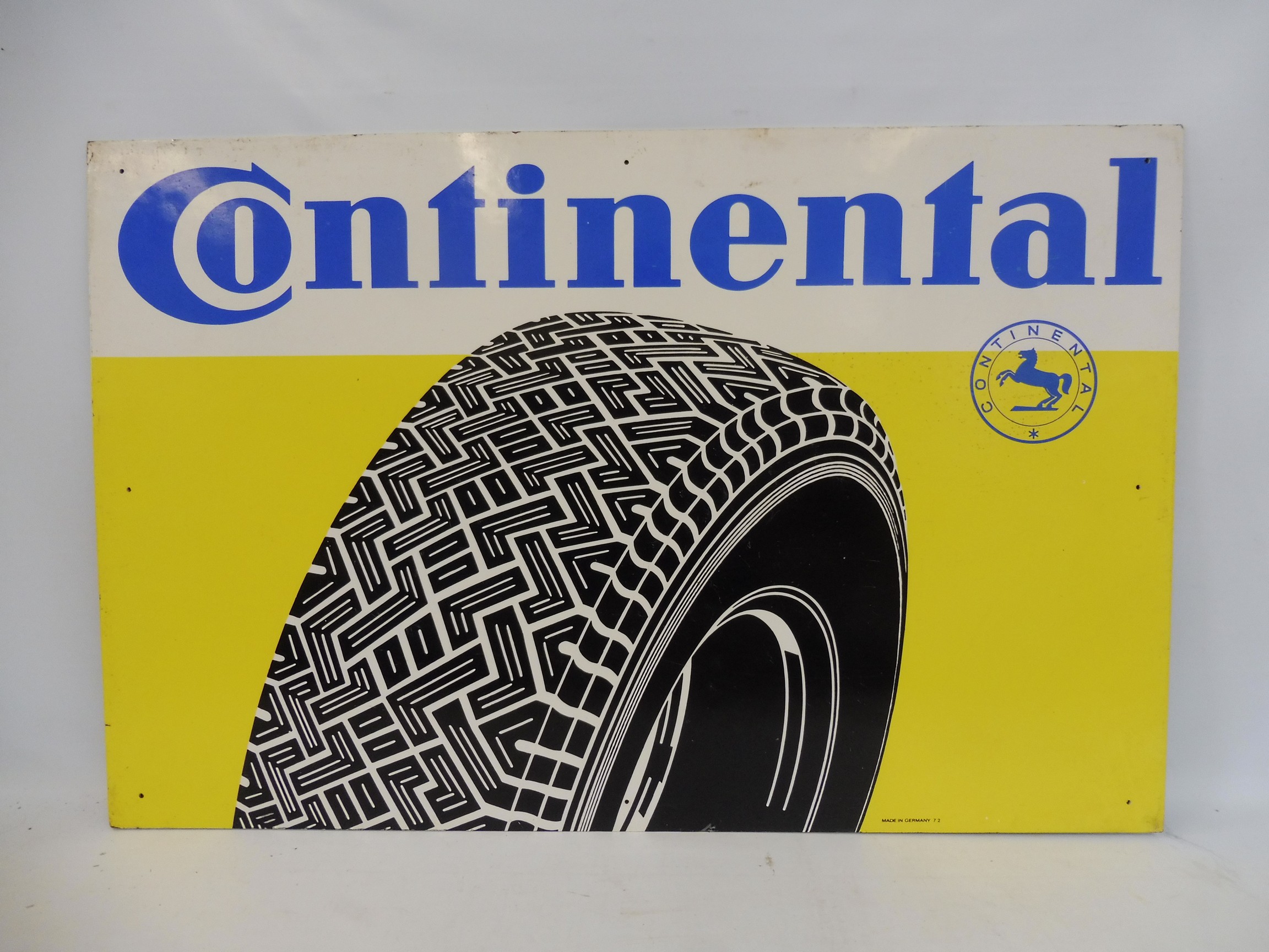 A large Continental hardboard advertising sign, 39 1/4 x 25 1/2".