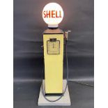 A well made and early wooden model of an electric petrol pump with sight glass and hose