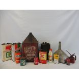 Two crates of assorted oil cans, a funnel etc.