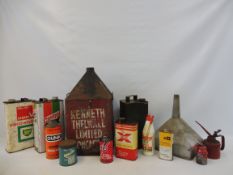 Two crates of assorted oil cans, a funnel etc.