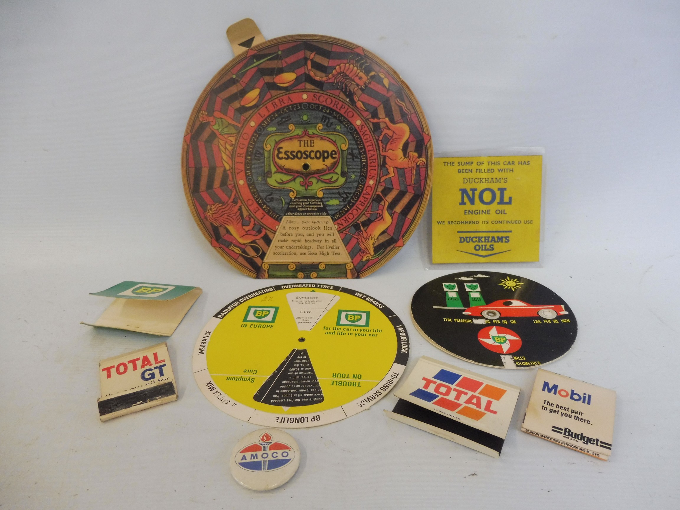 A collection of garage advertising items including BP, Duckhams, Total, Mobil, Esso and Amoco.