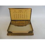 A Goodyear tyres advertising brass paper note holder and calendar.