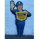 An unusual American tin advertising sign in the form of a standing policeman - Slow School Zone,