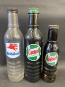 A Mobiloil quart oil bottle, a Castrol Motor Oil quart bottle and a pint Wakefield Castrol bottle.