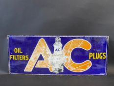 An AC Oil Filters and Plugs rectangular enamel sign with central plug image, 30 x 12".