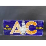 An AC Oil Filters and Plugs rectangular enamel sign with central plug image, 30 x 12".