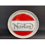 A contemporary Norton circular metal sign, 24" diameter.