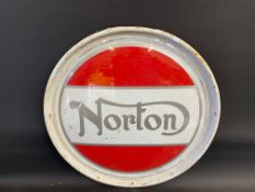 A contemporary Norton circular metal sign, 24" diameter.