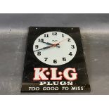 A K.L.G. Plugs glass fronted advertising battery operated wall clock, 10 1/2 x 14".
