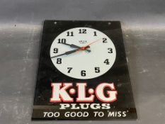 A K.L.G. Plugs glass fronted advertising battery operated wall clock, 10 1/2 x 14".