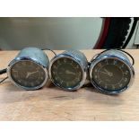 Three small Jaeger car clocks, appear to be new old stock.