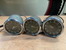 Three small Jaeger car clocks, appear to be new old stock.