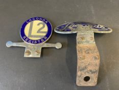 A Lagonda 2 litre Register enamel car badge by Fray no. 87 and an oval Lagonda Club badge.