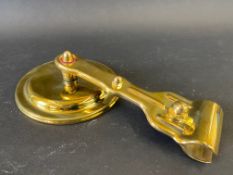 A polished brass windscreen pillar mounted exterior rear view mirror, probably American.