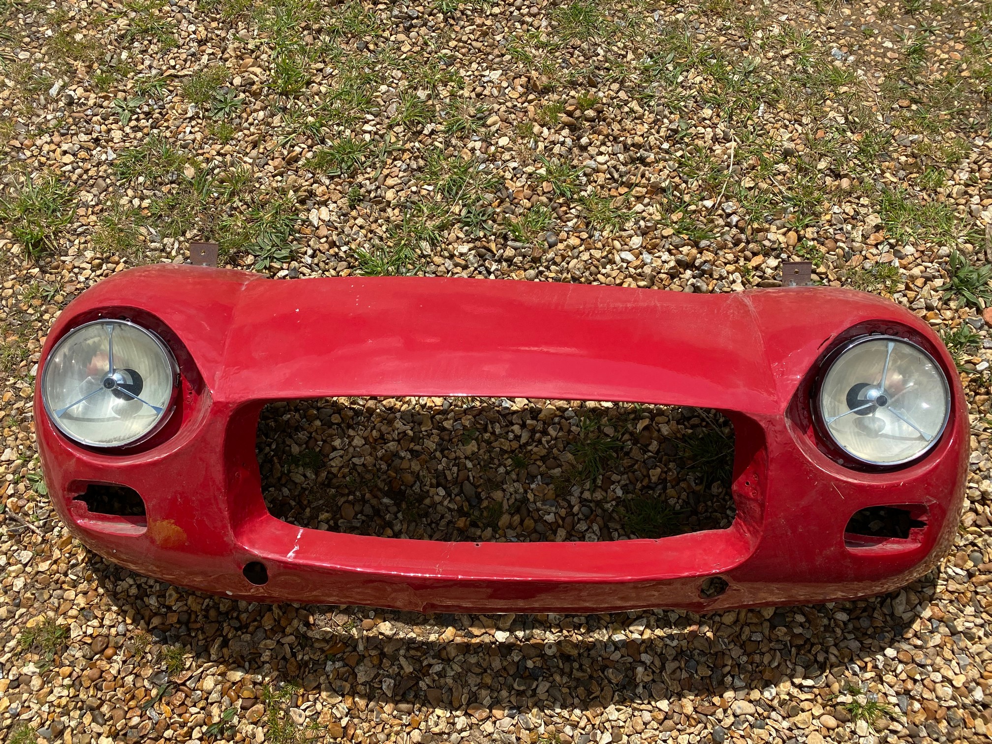 A front end of a classic car, mounted for display.