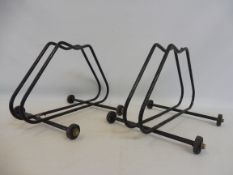 Two bicycle stands on wheels.