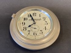 A good quality Stewart nickel plated eight day rim wind car clock with secondary dial.
