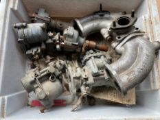 A box of carburettors and distributors, manifold etc.