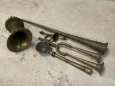 A brass electric horn and various horn parts.