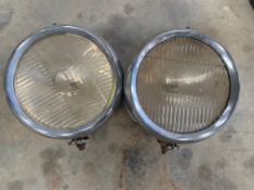 A pair of American drum headlamps.