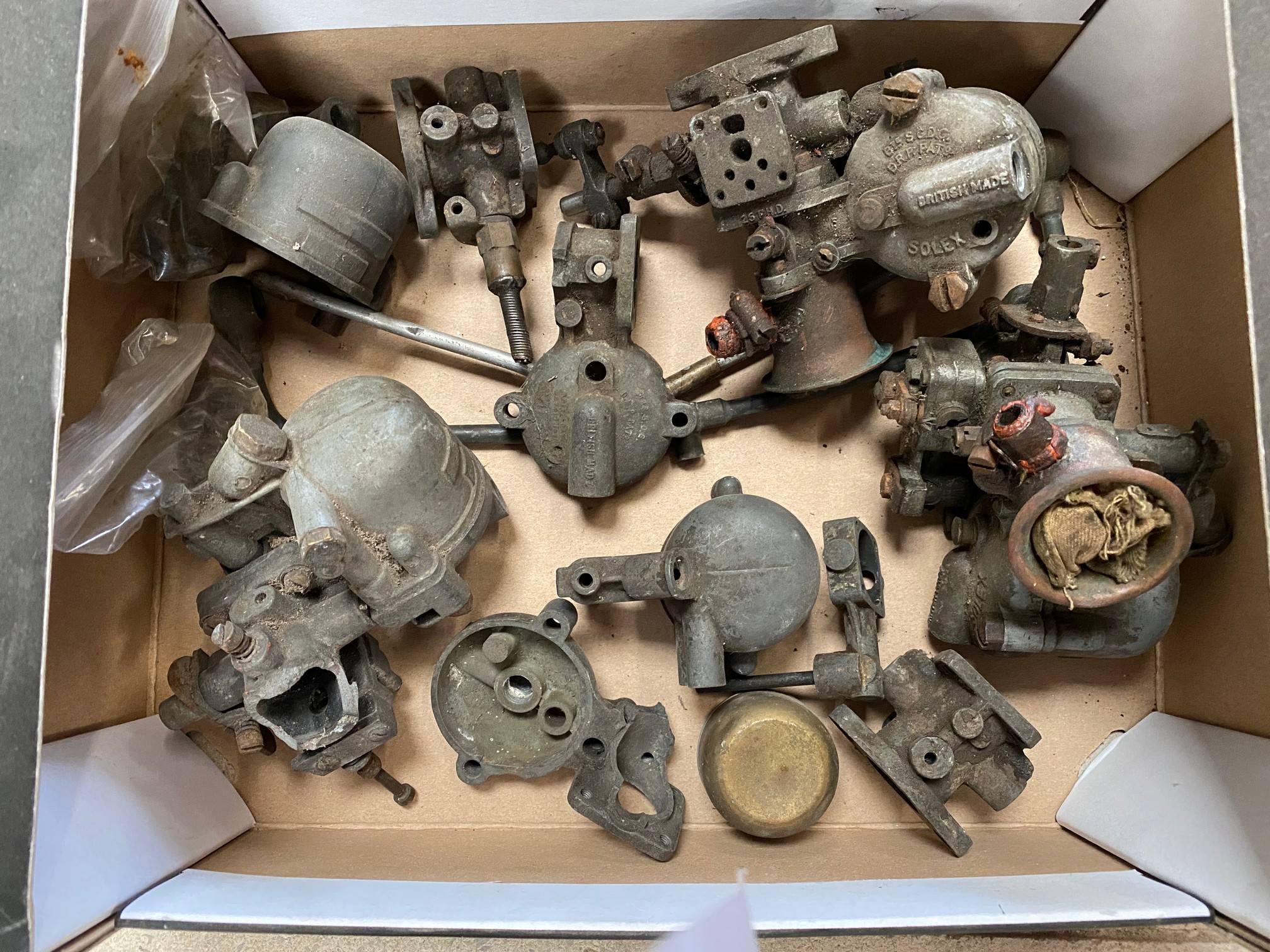 A box of Solex carburettor parts.