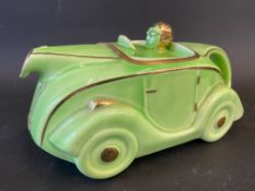 An Art Deco green glazed teapot in the form of a stylish racing car, impressed registration number