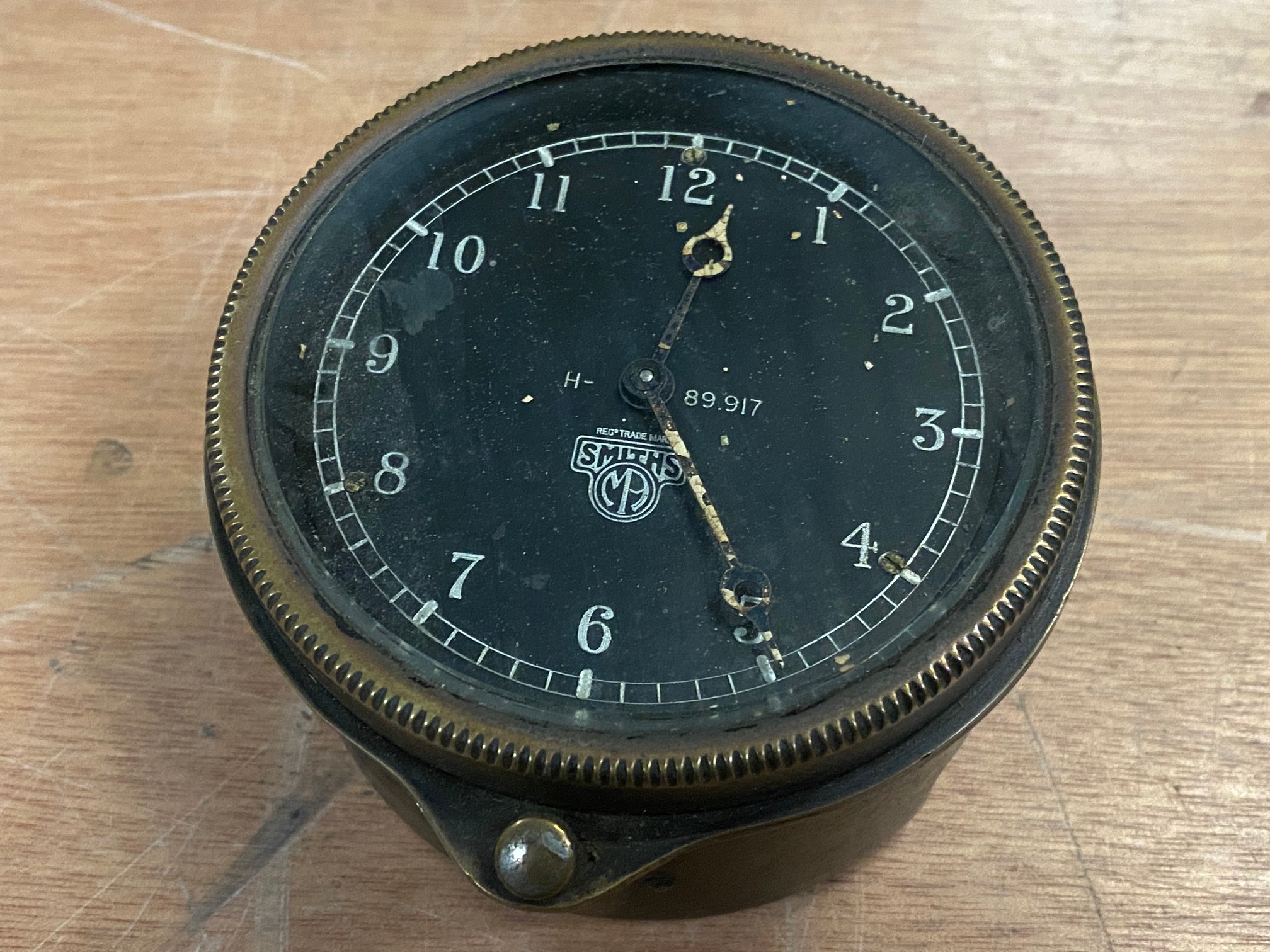 A Smiths black faced rim wind clock.