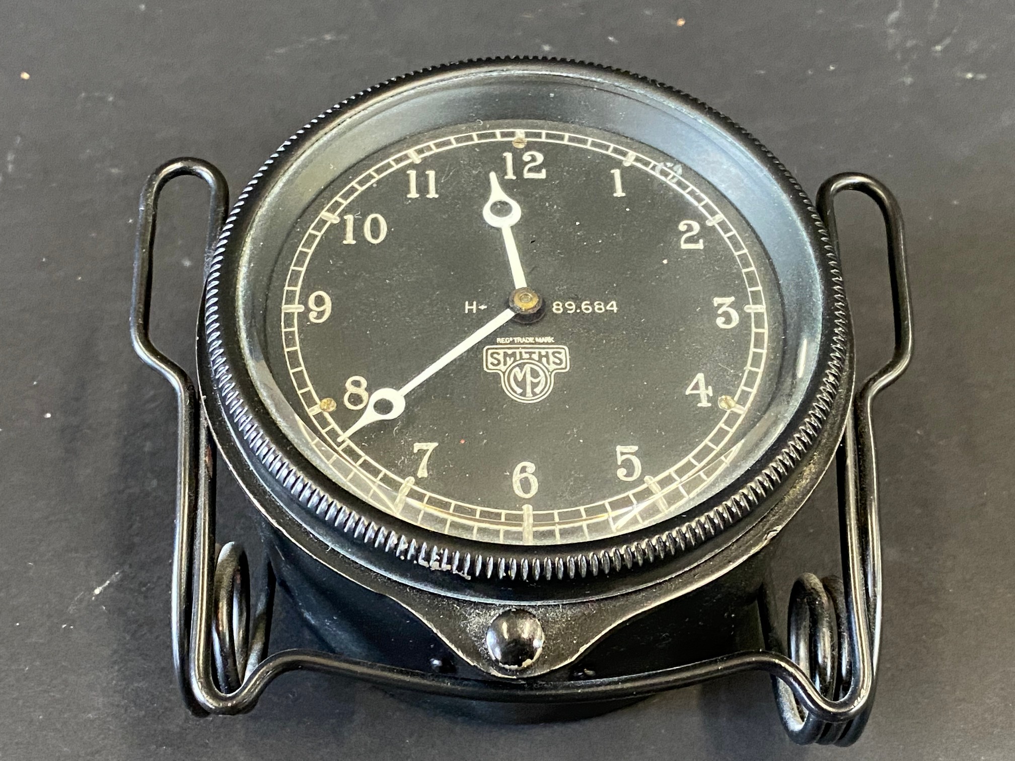 A Smiths black faced rim wind eight day car clock, appears in restored condition.