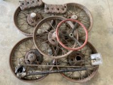 A collection of Austin 7 spares to include a set of five wire wheels, two cylinder heads, a steering