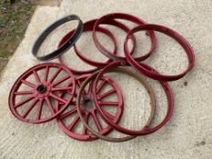 Two metal rimmed wooden spoked wheels and seven metal rims, possibly to suit Chevrolet; also a box