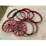 Two metal rimmed wooden spoked wheels and seven metal rims, possibly to suit Chevrolet; also a box