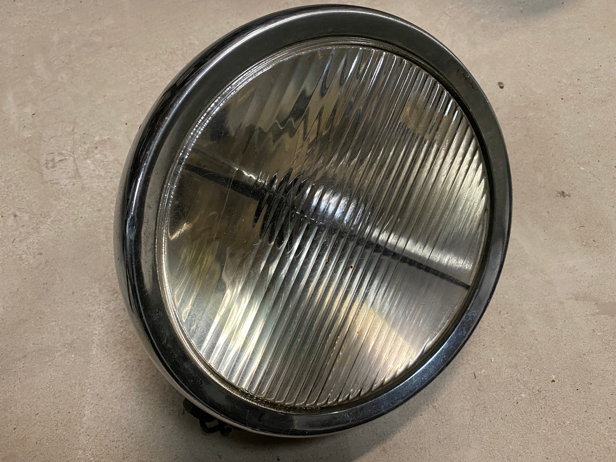 A 9" chrome plated Lucas spot or headlamp.