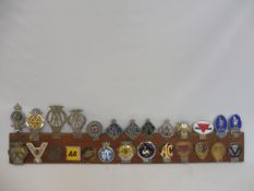 A collection of 26 car badges including early RAC, AC Owners Club, Invicta Car Club etc.