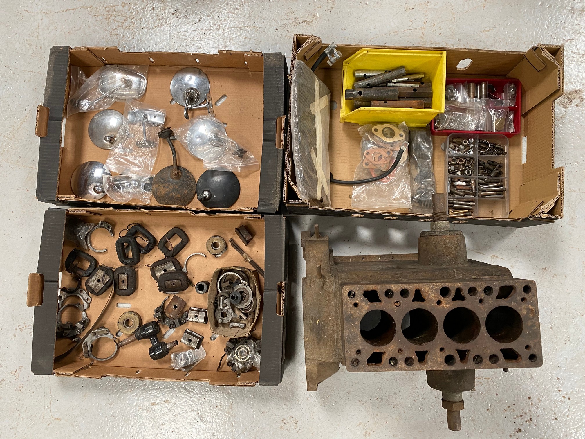 A Riley 9 cylinder block and three boxes of assorted mechanical parts and accessories including rear