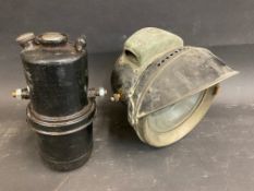 An early Lucas 6 1/4" motorcycle lamp with peak and unbroken reflector, sold with a generator,