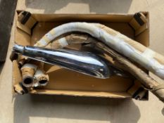 A Norton Dominator silencer and two exhaust down pipes, new old stock plus one exhaust down pipe