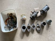 Carburettor parts including two racing Amal remote float chambers, a set of Manx inlet manifolds, GP