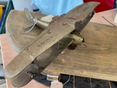An early tinplate clockwork model of an aeroplane, incomplete.