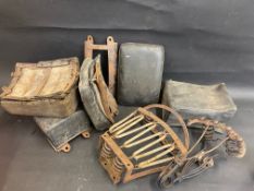 A tray of vintage motorcycle rear seats, including one pre-war example.