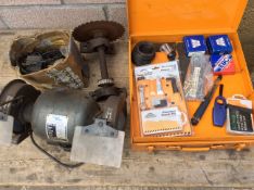 A box of general workshop items and a bench grinder.
