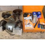 A box of general workshop items and a bench grinder.