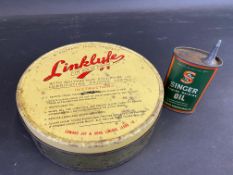 A Filtrate Linklyfe circular tin plus a small Singer sewing machine oil can.
