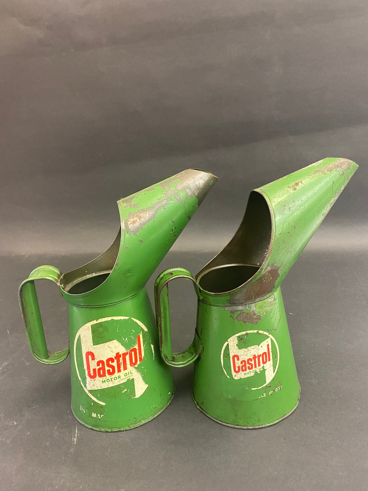 Two Castrol quart oil measures.