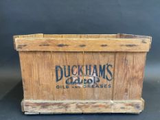 A rare Duckham's Adcol Oils and Greases wooden packing crate, for 12 cylindrical quart cans, 16 1/2"