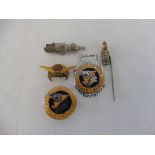 A small selection of lapel badges including Aeroshell, and one in the form of a spark plug.