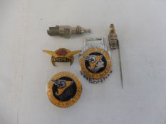 A small selection of lapel badges including Aeroshell, and one in the form of a spark plug.