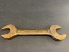 A bronze double open ended spanner, 1/2" and 9/16", probably a fuel tank or pump spanner, as being