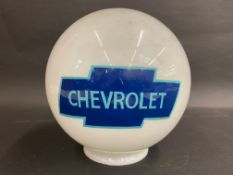 A spherical glass globe bearing a 'Chevrolet' decal.