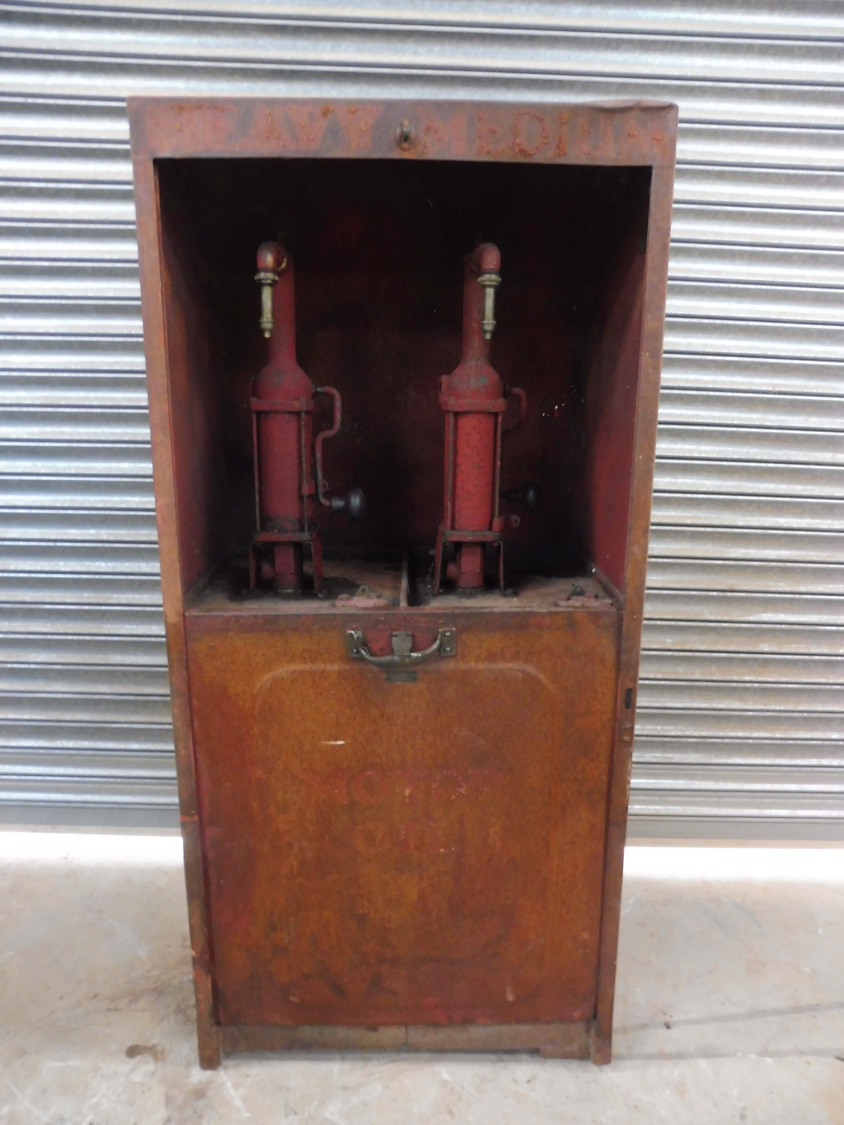 An early Shell garage forecourt oil cabinet with original robot/stick man decoration.