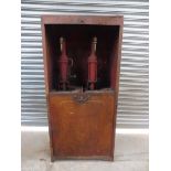 An early Shell garage forecourt oil cabinet with original robot/stick man decoration.
